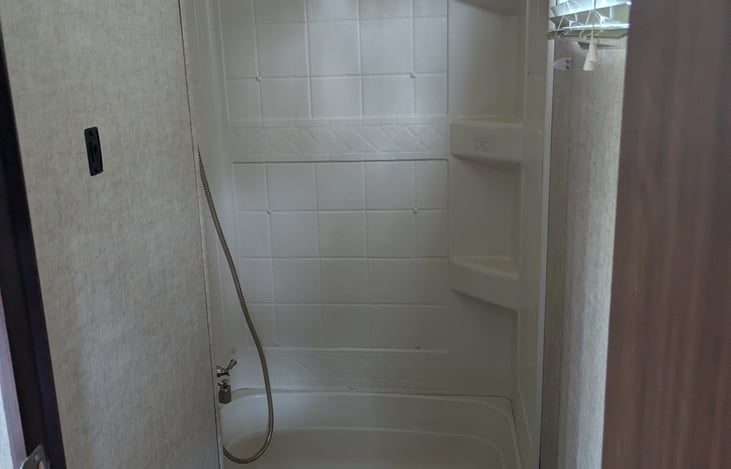 Small, but full bathroom located in the garage