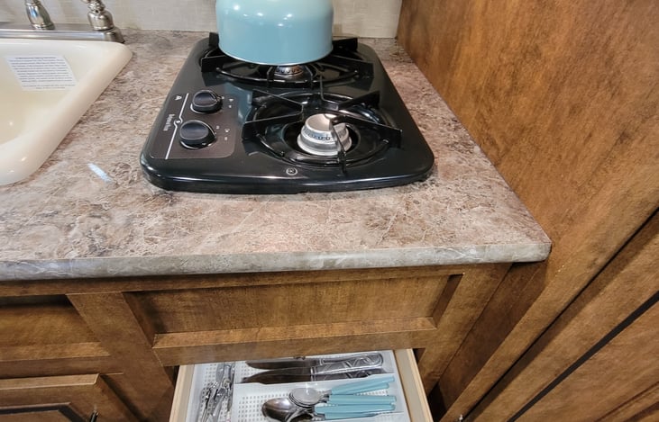 Water kettle for propane stove comes in handy when camping with no electricity.  Utensils and dishes included.