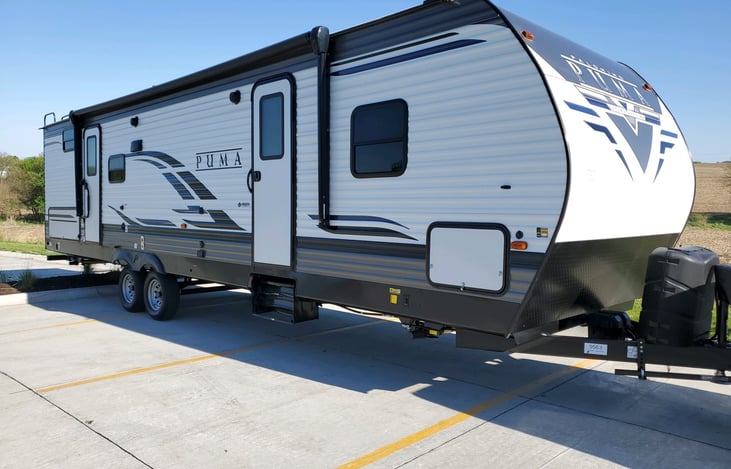 Two doors, outdoor kitchen, outdoor shower, awning, outdoor speakers.