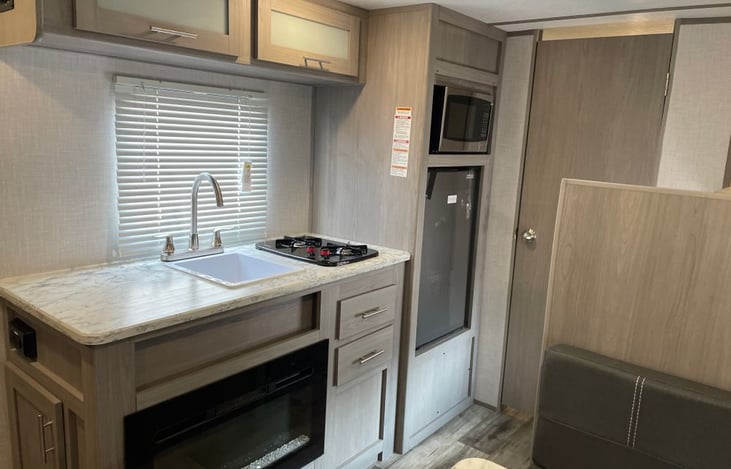 Stocked kitchen with a sink, 2 burner stove , refrigerator and of course, a Keurig.