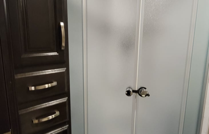 Front bathroom. Full shower, ceiling fan, make sure to open canopy when running the fan. Towel storage and drawers.