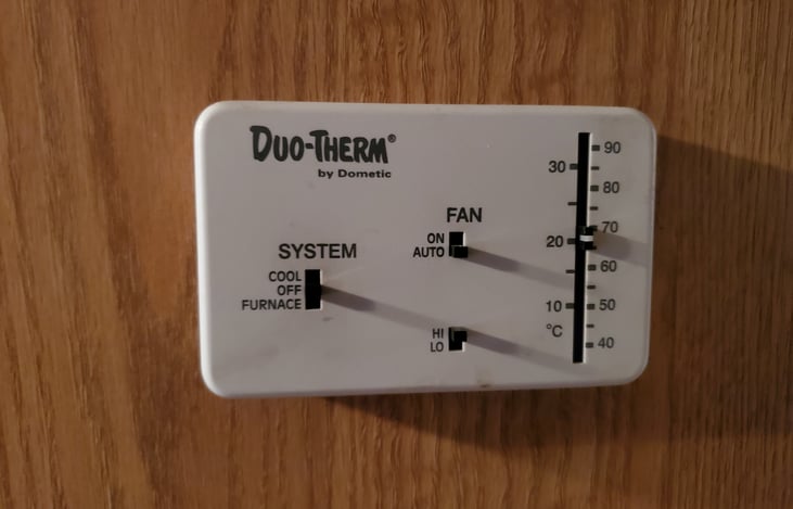 One of two thermostat controls for central ac/furnace systems