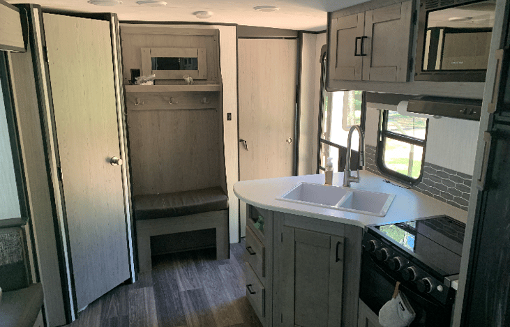 Large pantry - coat racks - small sitting nook - bedroom entrance - main door