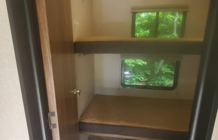 Top bunk can fold up for more head room during the day