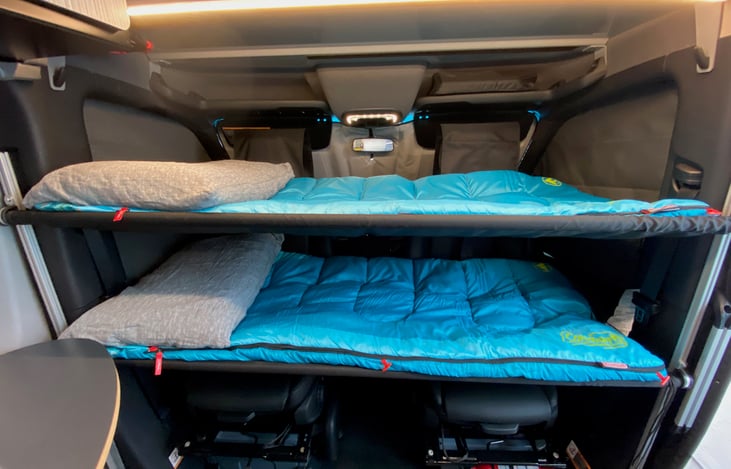 Bunk beds in the cab of the van. They are 62 inches long. (5'2")