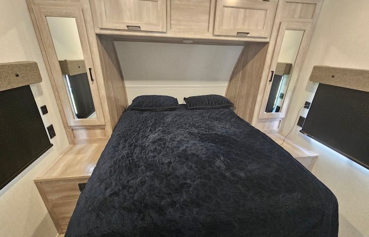 Bedroom with closets on both sides. Towels are located in the shelves at the foot of the bed. USB plugs on both sides of the bed.