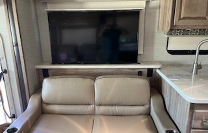 Tri-fold sofa and 50"TV lift. The tri-fold sofa unfolds to a queen air mattress