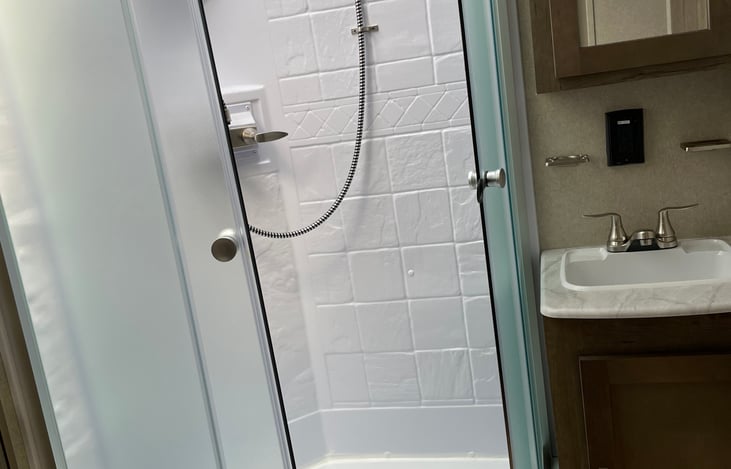 Master bath with corner shower and skylight.  Single sink.