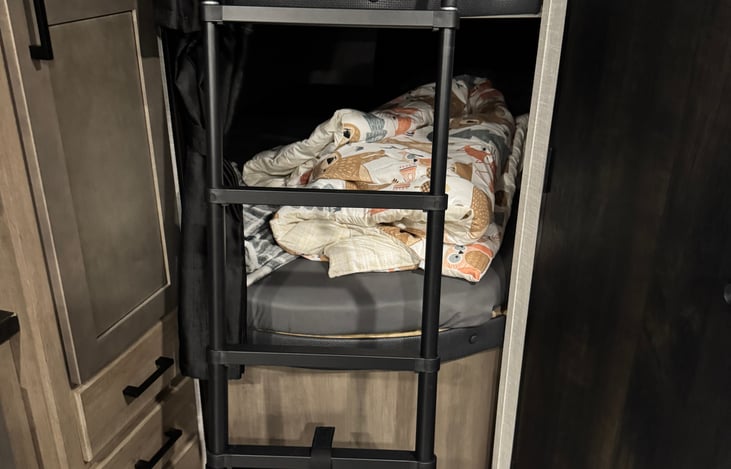 Double bunk beds - Big enough for adults too!
Shades for privacy, outlets and charging ports in bunk.
Removable ladder to reach the top bunk