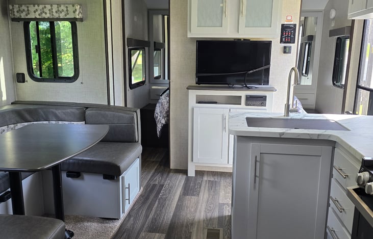Kitchen, dining area and back queen bed looking from bunk beds