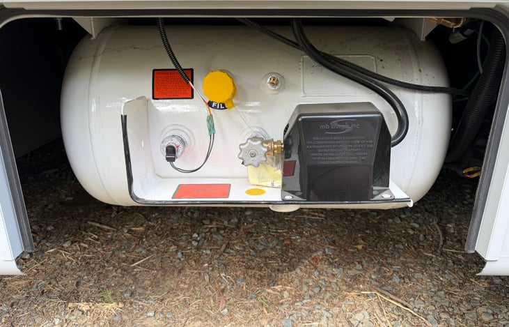 Large propane tank. Also has a hookup for a portable exterior stove if you got one. Propane is used for hot water and the heater.