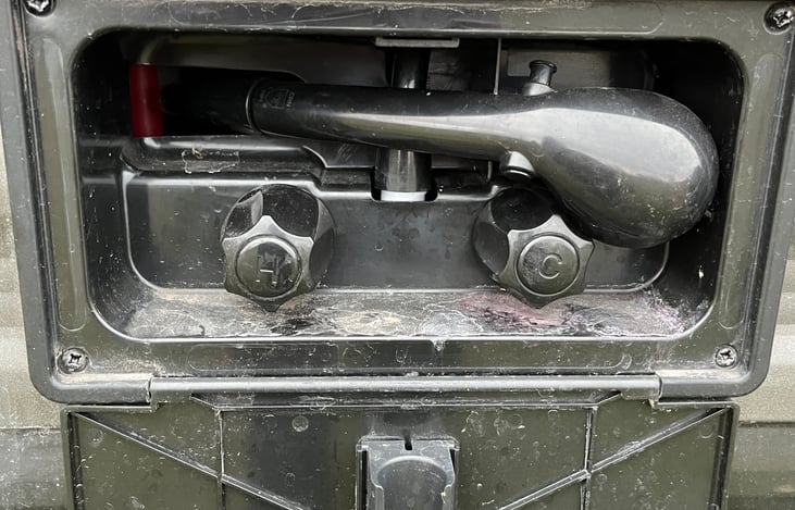 Outdoor shower has hot and cold water.