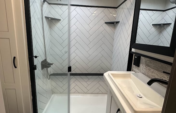o Full 48” x 30” rectangular shower with sliding glass doors and overhead skylight
o Large Sink w/ vanity LED lighting for any late-night calls
o The overhead air circulation fan keeps the steam out.