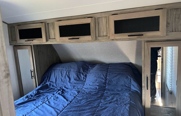 Super comfortable queen size bed. With 4" mattress topper, and all linens. Doors, not curtains, for a little extra privacy. And LOADS of storage in this room.