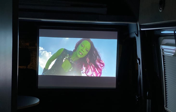 Smart Projector with 40inch screen. Watch shows inside our outside. Netflix, Hulu, YouTube, Disney+, etc. can be used via the app in the projector or you can stream from your phone/tablet.