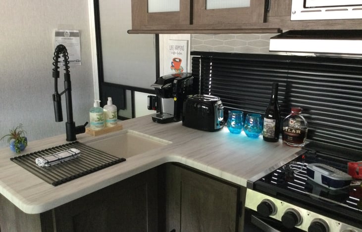 Fully stocked kitchen, 3 burner stove, microwave, coffee (Keurig) and toaster, oven, 2 sided sink.