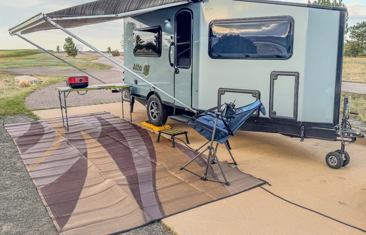 With provided mat, optional table, and BBQ.