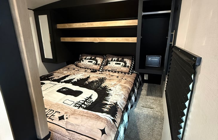 Bedroom with closet space on each side plus 2 shelves up top. There is also storage under the foot of the bed.