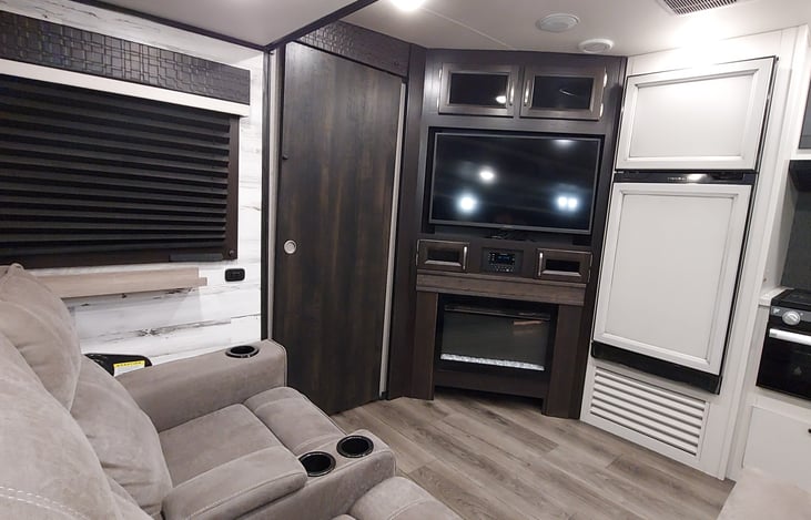 Fireplace, HD TV, Entertainment Center and Fridge/Freezer to the right