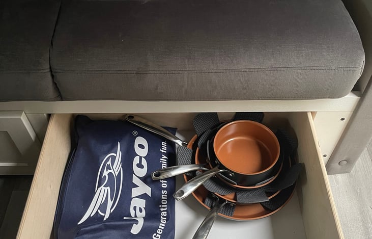 We provide one small pot & 3 pans. Cookware such as spatulas but we do not provide bowls/ cups/ utensils.