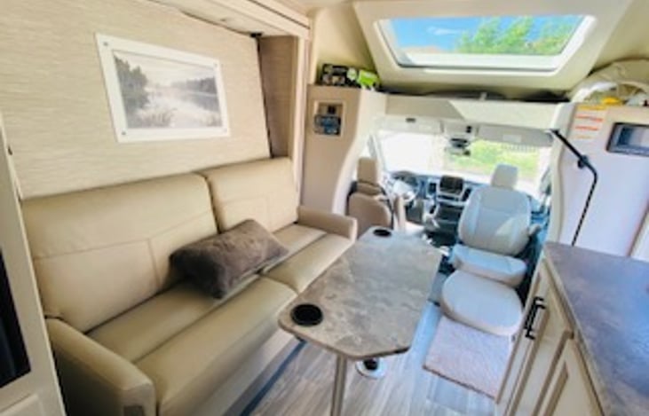 Behind this comfortable leather couch is a pull down murphy bed