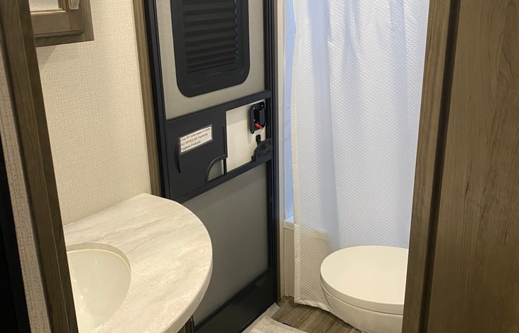 Bathroom with sink, toilet, tub shower combo.