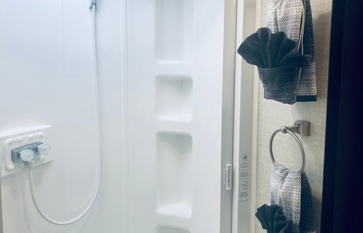 Full size bathroom with heated indoor/outdoor showers and amenities.