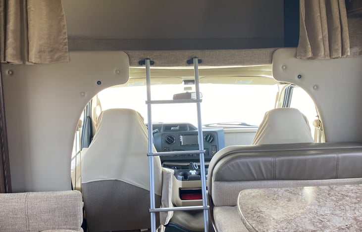 Queen bed above the cab with swing out TV