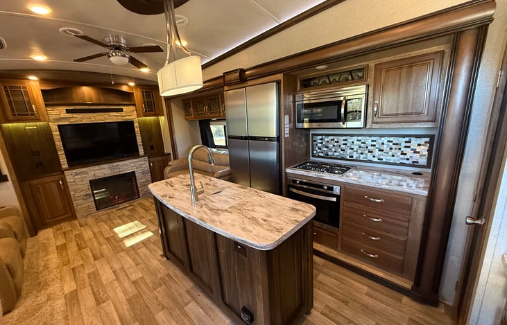 3 burner gas stove, conventional microwave and fridge/ freezer. Full pantry