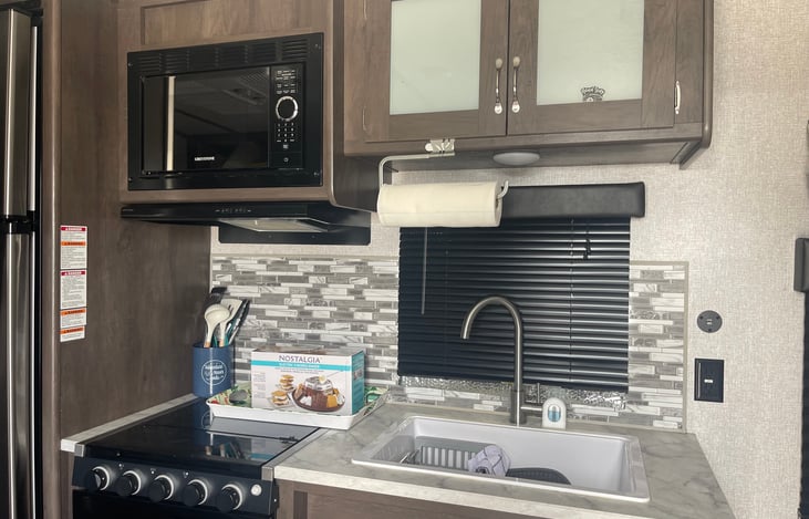 Double Full Size Bunks each with light and USB charging docks.
Outdoor kitchen also has a sink, burner, and refrigerator. Blackstone Grill and table provided.