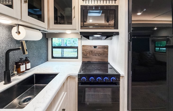 Hand soap, dish soap, paper towels, and stocked kitchen essentials included.