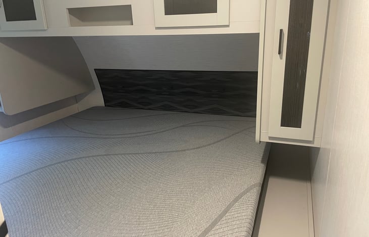 Master bedroom complete with a King size bed and storage for hanging clothes on both sides. Storage above and below the bed. USB ports and outlets on both sides of the bed for your convenience.