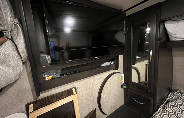 Built-in flat-screen TV connects to. DVD player. I also installed a large projector screen for a larger movie size option.