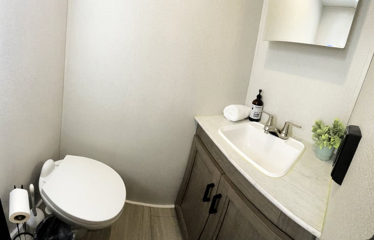 Second bathroom just off of the master bedroom has plenty of storage and double outlet.