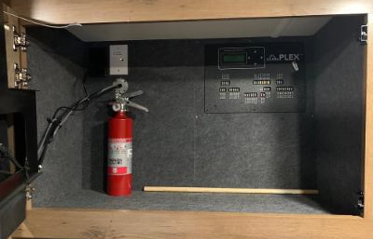 Fire Extinguisher, Storage behind bedroom TV with fuse panel, & selector for TV cable or ant, operation. Geen light on ant. is selected.