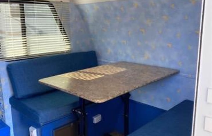 This dining table can be lowered to create a bed.