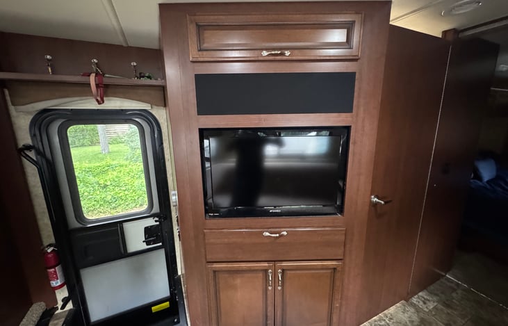 The living room TV features Apple TV and a complimentary guest account for Amazon Prime, Apple TV, and Paramount. It includes a soundbar and subwoofer.