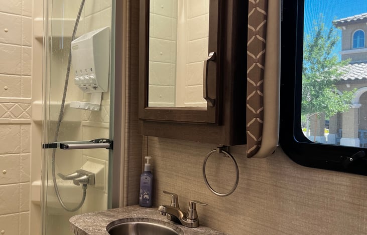 Shower has push buttons for shampoo, conditioner and body wash.