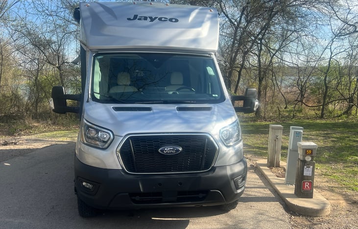 Built on the Ford Transit 350HD AWD chassis, this off-road ready motorhome features all-terrain tires with custom matte black wheels and the JRide ride.
