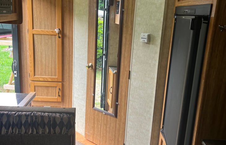 Refrigerator, full length mirror and a closet