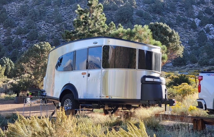 Yes, it has a bathroom. And a kitchen. And a lounge area that turns into a bed. Explore how Airstream packed everything you need into its best-selling camper to configure the perfect Basecamp.