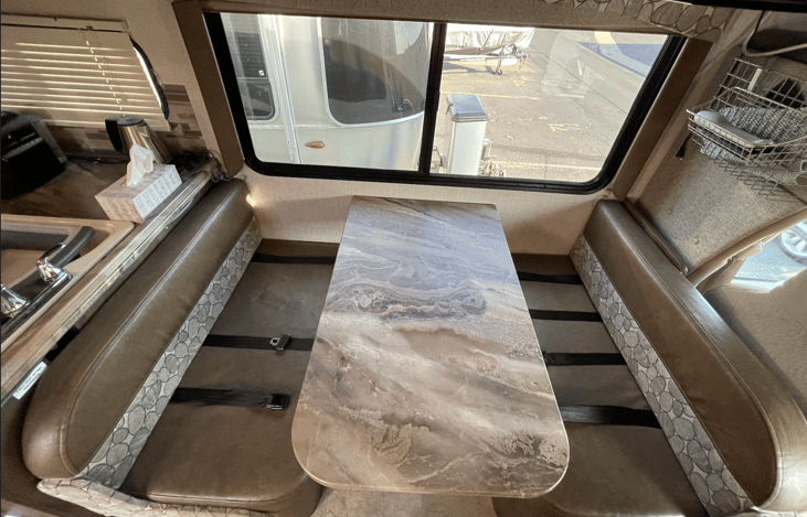 Seating for 4 to eat around the table, and more on the 3-piece sofa. There are seatbelts so you can sit there while the driver is driving too... (our kids play games).