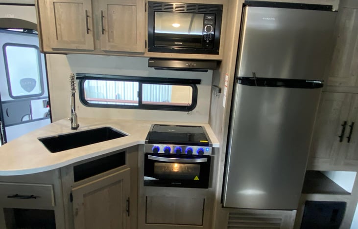 Kitchen with oven and fridge.