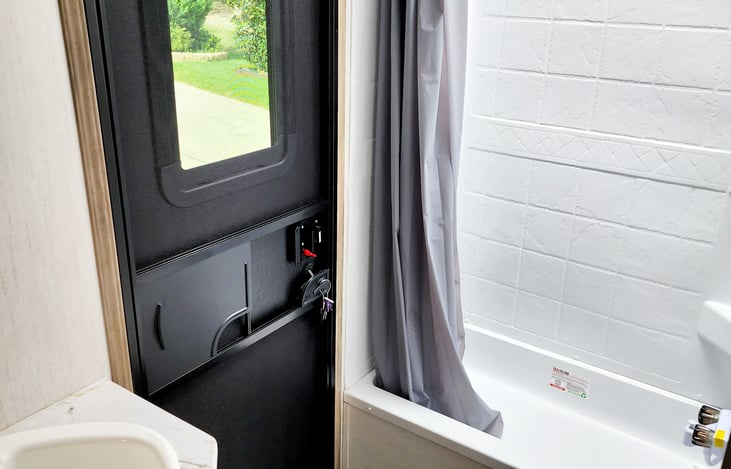 Bathroom with shower and entry door for easy access from outside