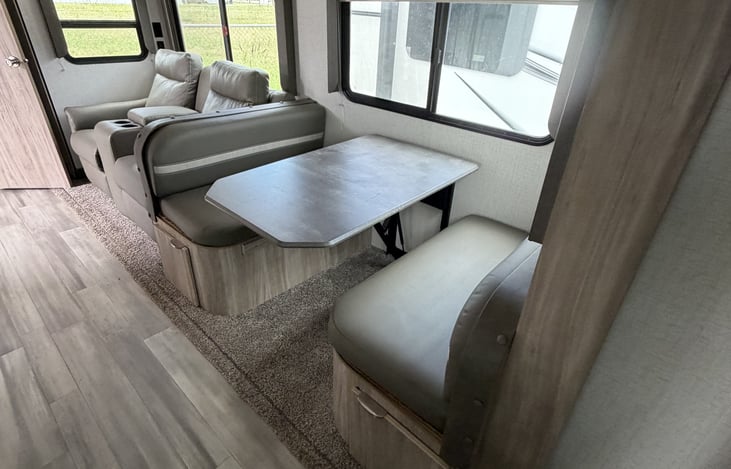 Theater seats and kitchen dinette are pictured