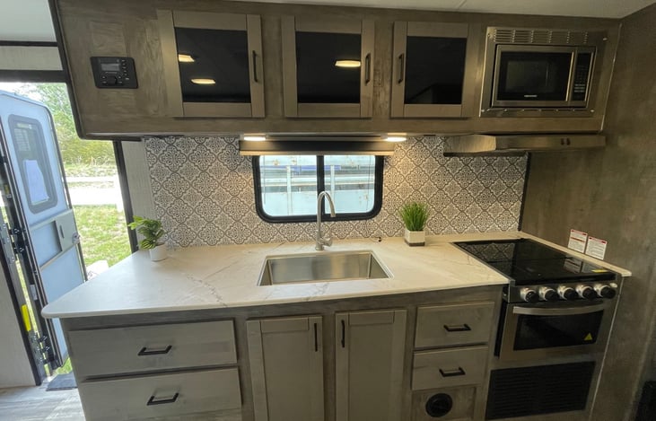 Featuring oven, stovetop, microwave, fridge, and pantry. Kitchen is fully equipped with cookware and utensils