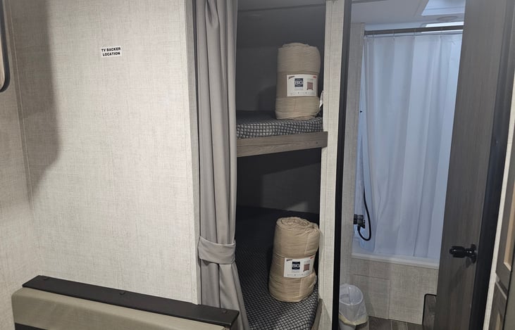 Bunkbeds with full size mattresses and privacy curtain. Lights in ceiling per each bed