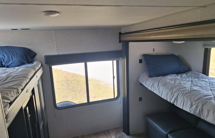 3 beds in bunk room.  Couch makes a full size bed. There is room for a mattress on the floor as well