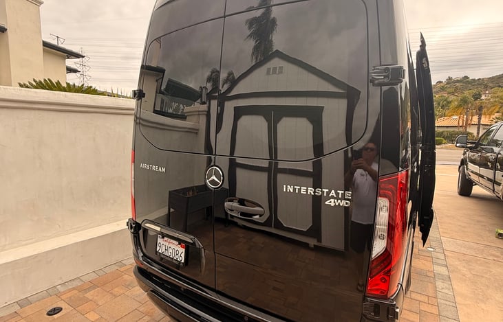 Open double door to storage underneath bed. Room for luggage, golf clubs or bags.