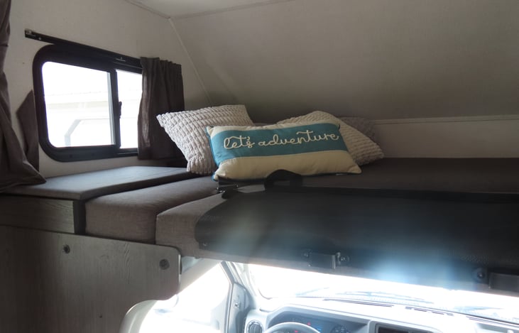 Full size bed over cab. Windows on both sides offers a good view and allows for natural lighting!